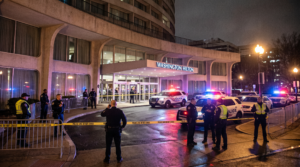 Police officers and squad cars outside the Washington Hilton hotel at night following the White House Correspondents Dinner shooting