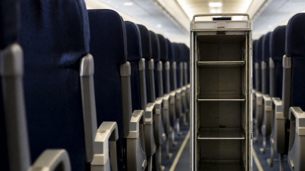 Empty airline service cart in economy cabin