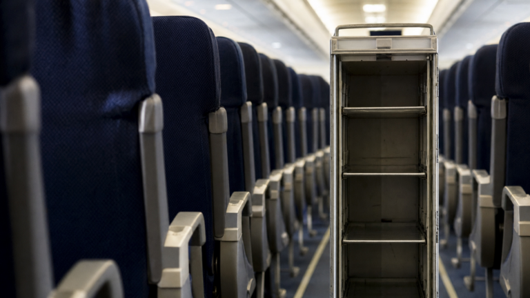 Empty airline service cart in economy cabin