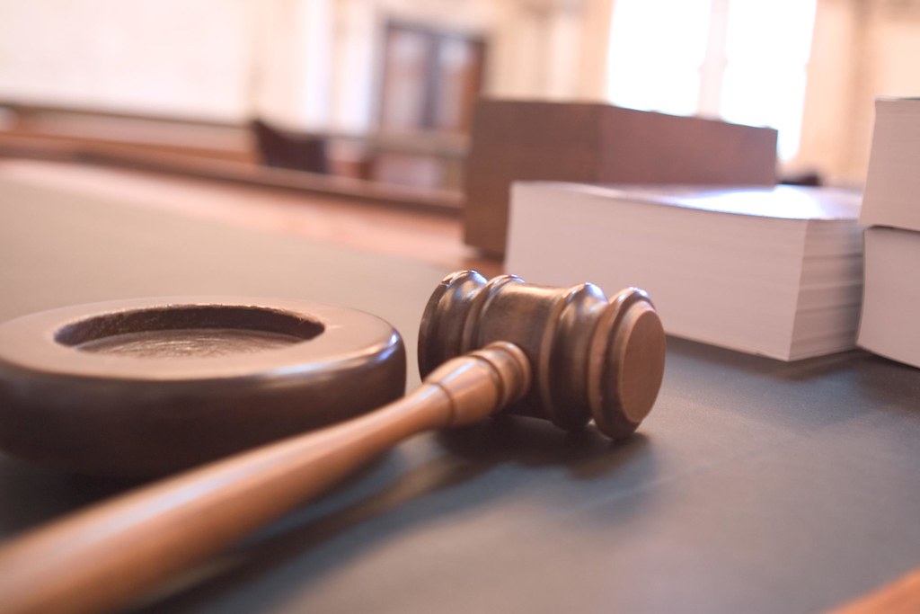 Wooden judge gavel resting on a desk