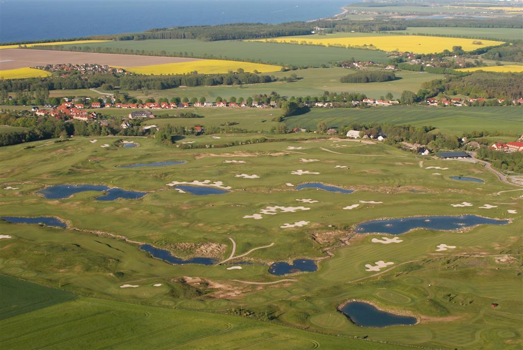 Golf course fairway and green under clear sky